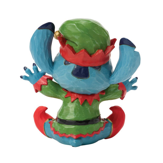 Dit charmante Disney Traditions beeldje van Stitch als Mini Elf is perfect voor Disney-fans en verzamelaars. Ontworpen door Jim Shore, met folkloristische patronen en handgeschilderde details, is het een hoogwaardige decoratie en een ideaal cadeau tijdens de feestdagen of het hele jaar door.