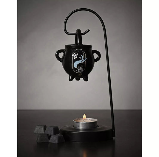 Wax melt brander van zwart keramiek met iconische figuren uit The Nightmare Before Christmas, inclusief een uitneembaar schaaltje en metalen standaard.