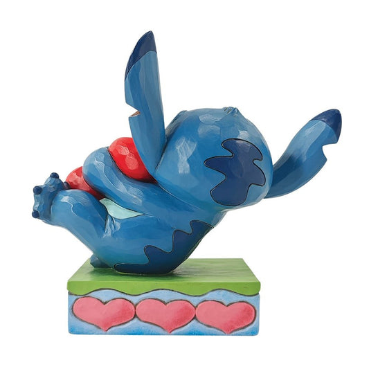 Disney Traditions figurine van Stitch die een hart vasthoudt, ontworpen door Jim Shore in folk-art stijl, perfect als cadeau.