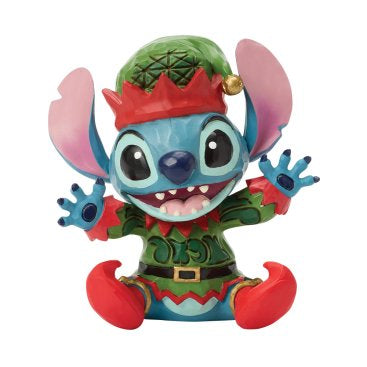 Breng de magie van Disney en de kerstsfeer samen met dit Disney Traditions Stitch Mini Elf beeldje. Met zijn vrolijke glimlach en schattige elfenkostuum straalt Stitch zijn ondeugende karakter uit. Het handgeschilderde ontwerp van Jim Shore maakt dit beeldje tot een uniek en feestelijk verzamelstuk.